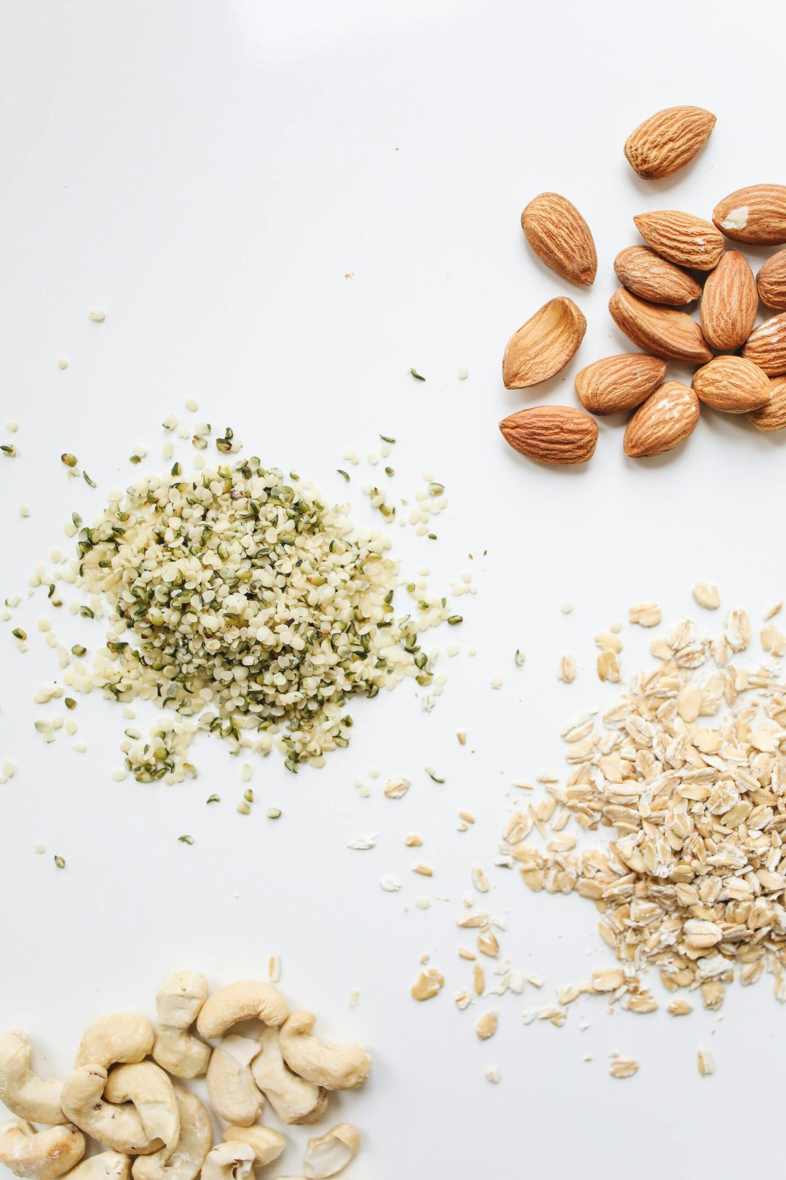 Assorted nuts and seeds, including almonds, hemp seeds, and cashews, highlighting healthy fats as essential for hormone health and sustained energy