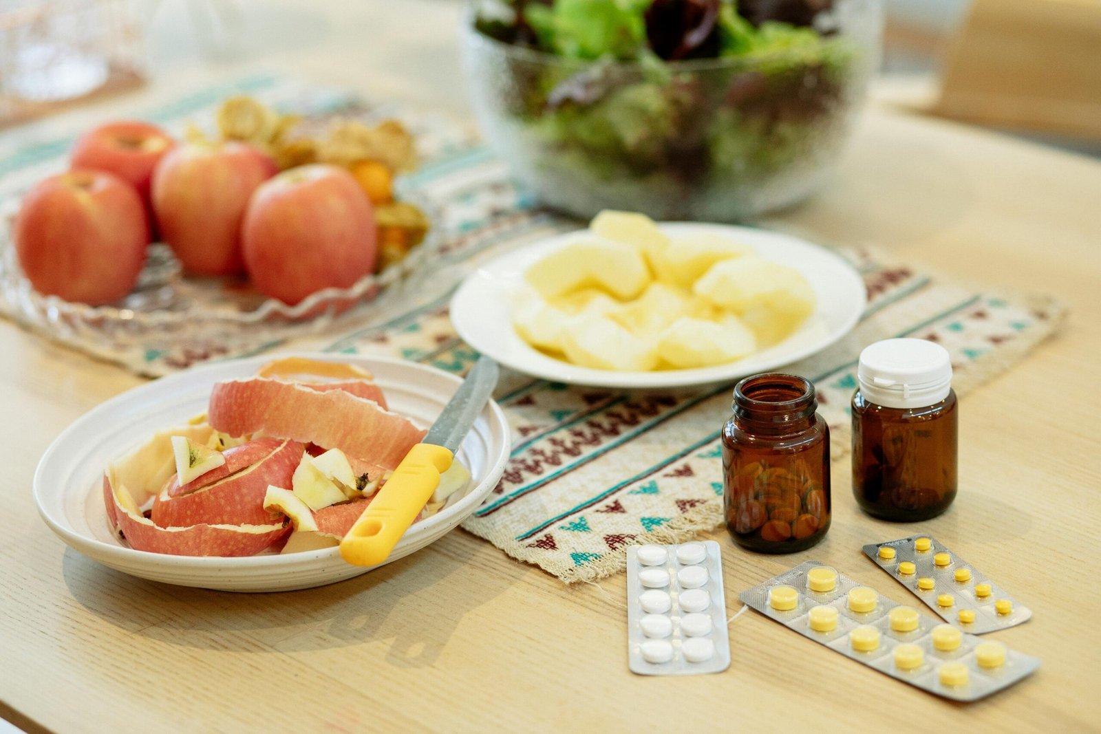 Apples, salad, and supplements illustrating the comparison between food and supplement sources of micronutrients.