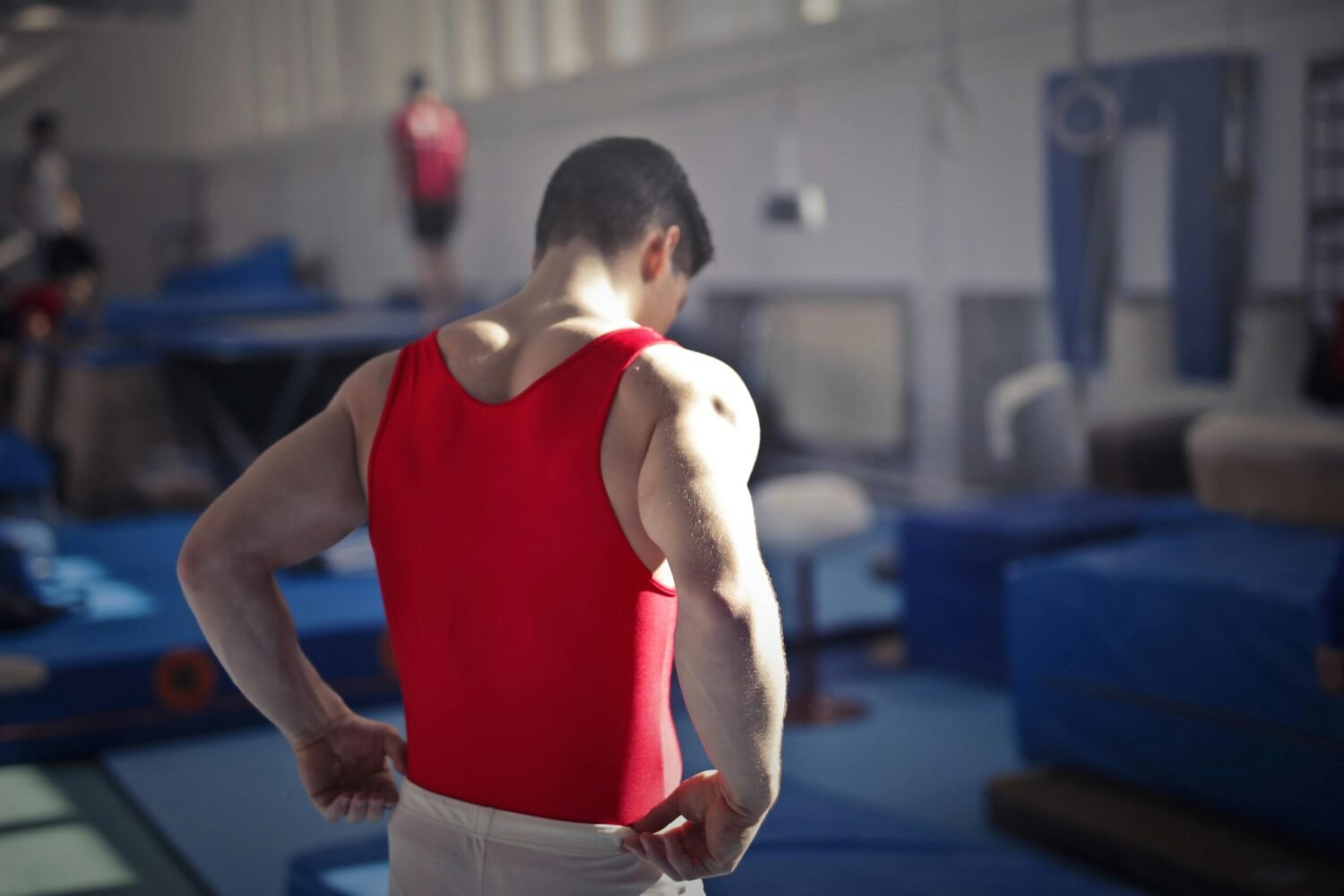 Man standing with his back towards the camera, preparing to to start his workout