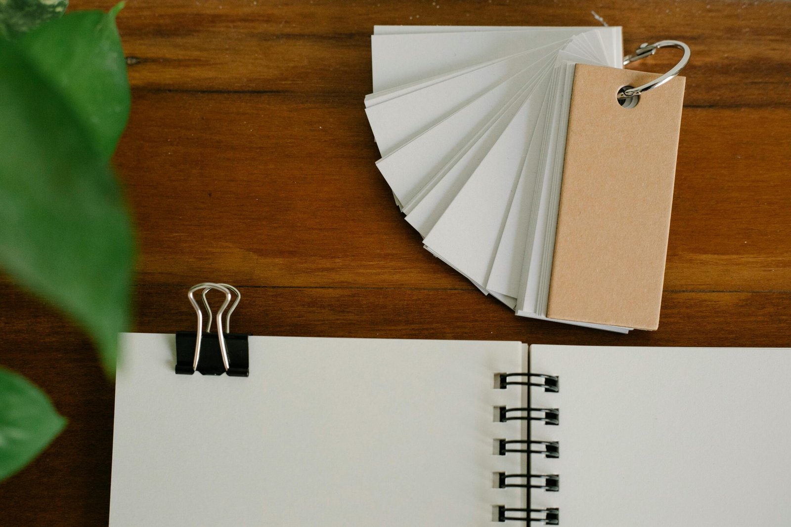 Flashcards and a notebook on a desk used for active recall studying.