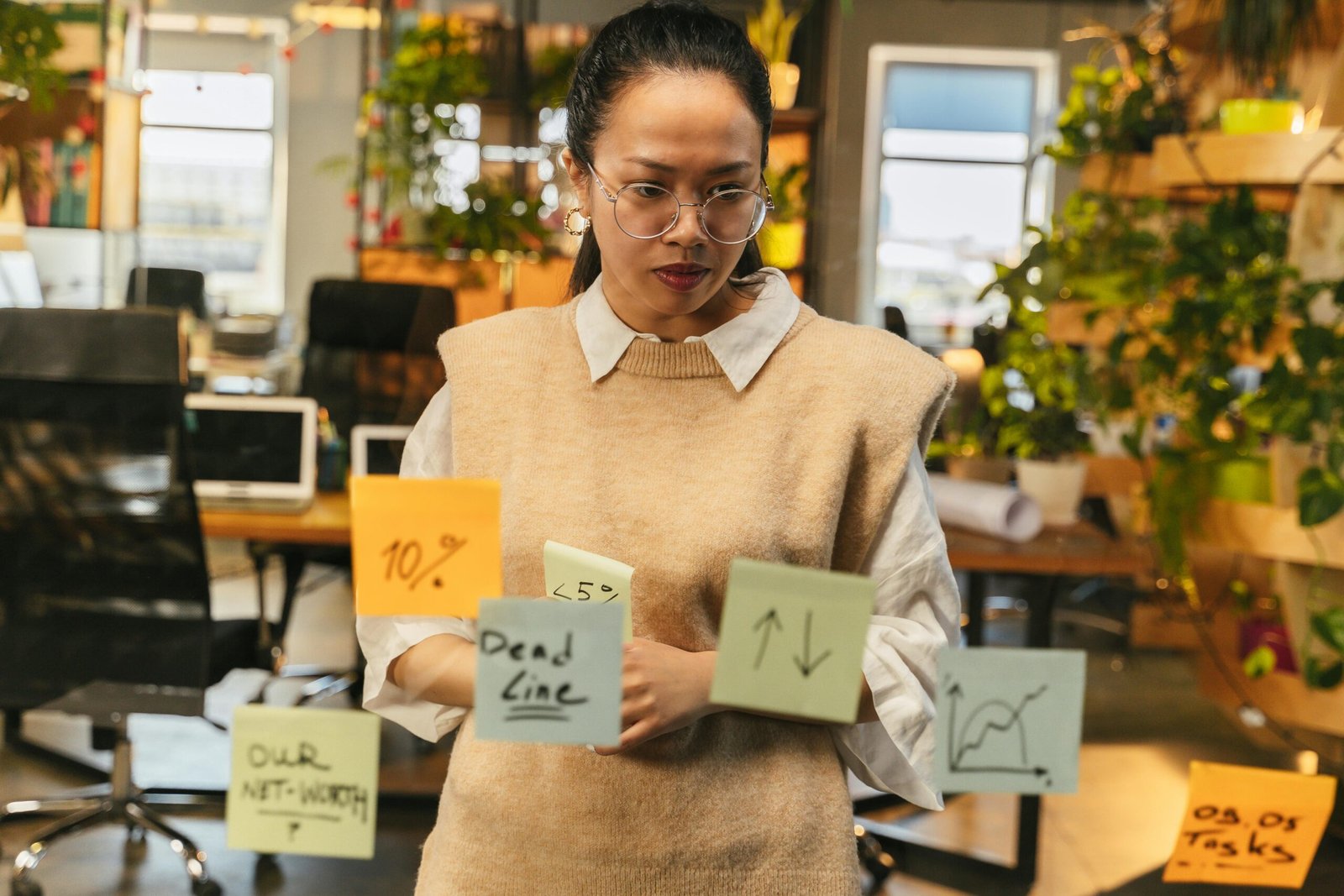 Person reviewing sticky notes with goals, symbolizing the importance of knowing your 'why' to boost motivation for studying.